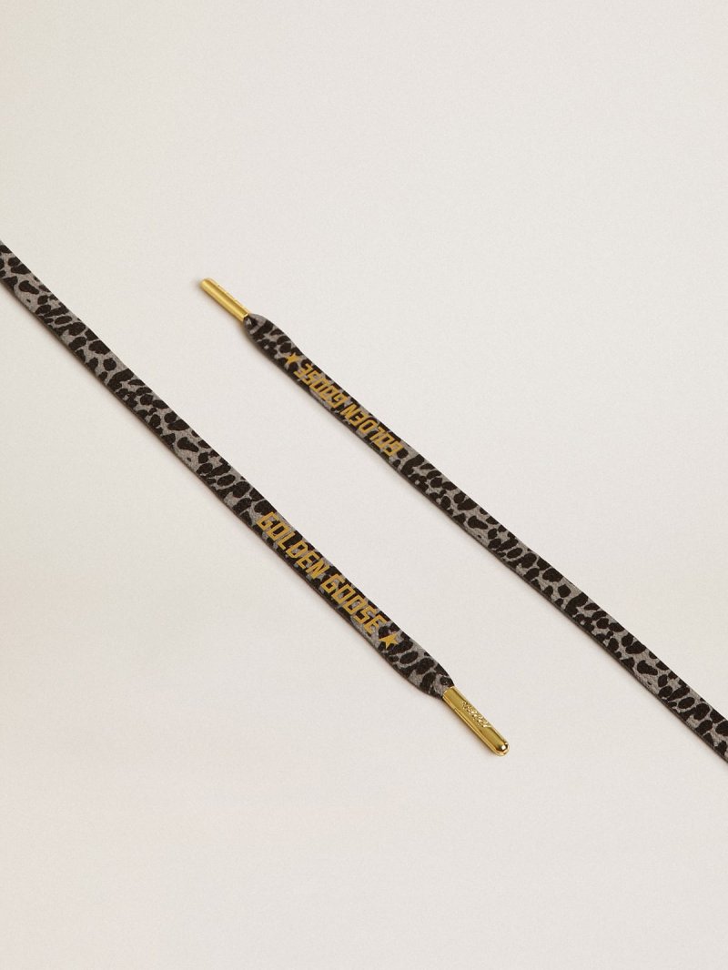 Black and white animal-print laces with contrasting gold-colored logo